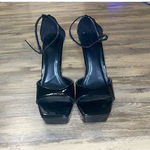 Black latex high heeled pumps